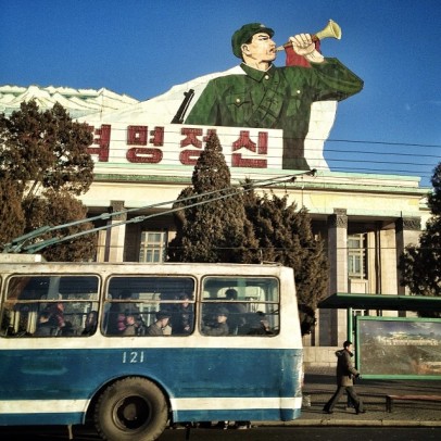 A passing bus and sign in Pyongyang, North Kora. Credit: David Guttenfelder via Instagram